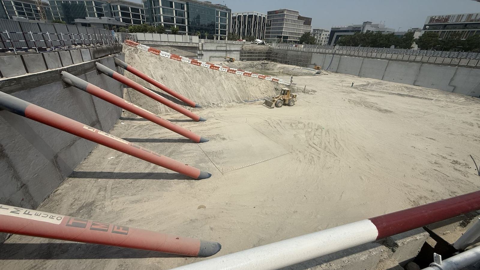 TMF-branded raking struts supporting a deep basement wall